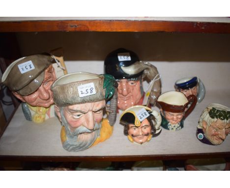 Three large Royal Doulton toby jugs: 'Gone Away', 'Robinson Crusoe', 'The Gardner'; and four small Royal Doulton character ju
