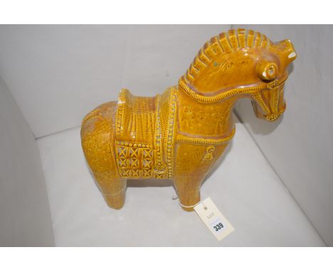 A reproduction ceramic figure of a Chinese horse, saddle and bridle (damaged and repaired).