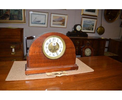 An Edwardian mahogany domed clock with arabic enamel dial.