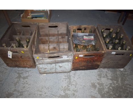 Four vintage wooden lemonade crates containing twenty-nine Fentimans glass bottles.