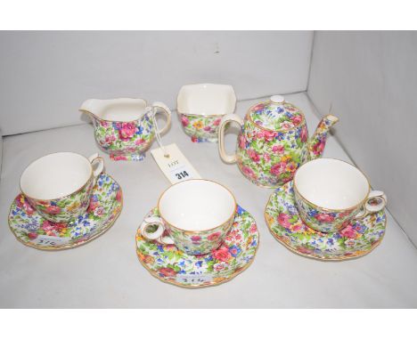 Three Royal Winton 'Summertime' pattern coffee cups and saucers; a small coffee pot; a cream jug; and a sugar bowl.  (9)