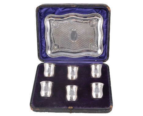 A set of six 19th century French white metal port cups and tray, the cups with ridged horizontal lines and evenly spaced poin