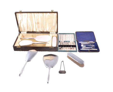 Two silver-backed dressing table sets, silver coffee spoons and small silver-plated serving set, a pink enamel and silver-bac