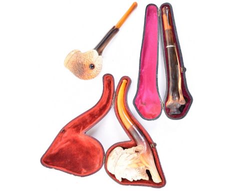 Finely carved meerschaum pipe bowl in the form of an Arab’s head with stem, in its leather-covered case; and another carved a
