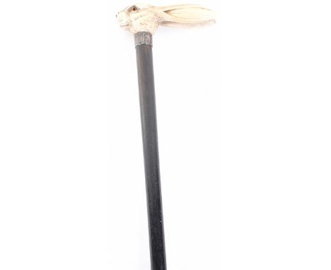 ^ Walking stick 33” with ivory handle finely carved as a rabbit’s head, inlaid eyes, ebonised shaft with silver ferule H.M. L