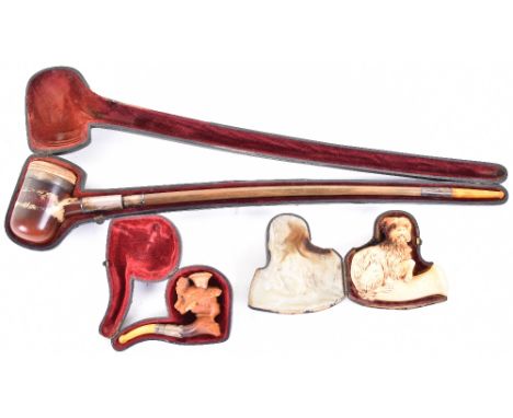 Finely carved meerschaum pipe bowl in the form of a terrier, in its leather-covered case; another depicting a leady in fancy 