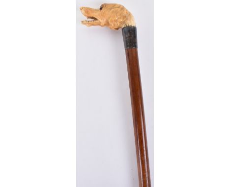 ^ Gentleman’s walking stick 34.25”, ivory handle carved as a dog’s head, inlaid glass eyes, Malacca shaft, silver ferule H.M.