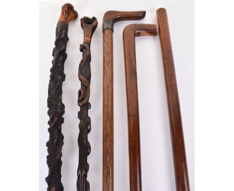 5x assorted wooden walking sticks c.1900; the first possibly African carved in high relief with 4 lizards, 2 snakes, the hand