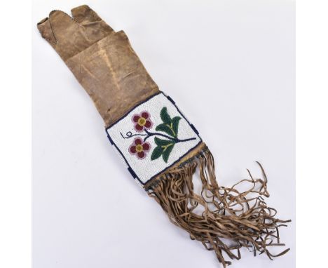 Native American beadwork, probably first half of the 20th century,  decorated leather pouch overall height 21” (excluding fri