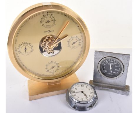 Electric timepiece in gilt case, 7.5” by Howard Miller with seconds dial, thermometer, barometer and hygrometer, back stamped