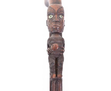 Maori carved wooden walking stick c.1900, 38.5” with typical bands of dentil decoration in relief, and 2 figures inlaid with 