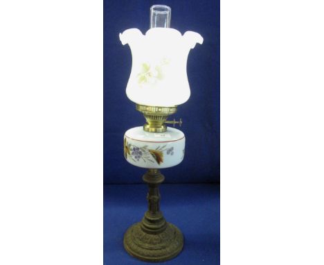 Brass double burner oil lamp with glass florally painted reservoir on cast metal base, opaline glass shade with clear chimney