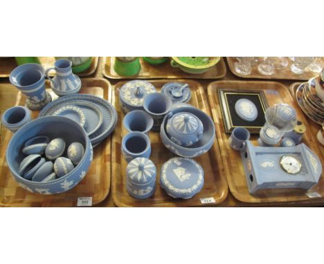 Three trays of Wedgwood blue and white Jasper ware items to include: various egg shaped trinket boxes; vases; mantel clock; p