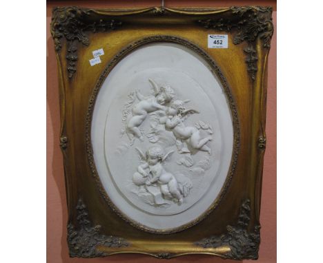 Ceramic relief panel depicting cherubs, oval, within in gilt frame, 37 x 28cm approx. (modern)(B.P. 24% incl. VAT)
