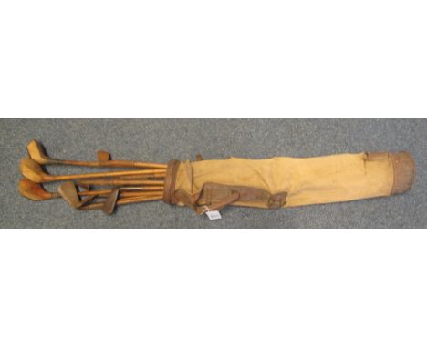 Set of vintage hickory shafted golf clubs in old canvas, leather trimmed bag.(B.P. 24% incl. VAT)