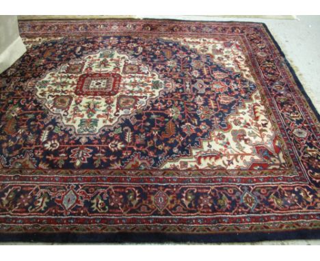Large Middle Eastern design blue ground foliate carpet.(B.P. 24% incl. VAT)