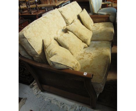 Modern, foliate upholstered, large, two seater sofa on a cane and wooden frame.(B.P. 24% incl. VAT)   CONDITION REPORT:  Over