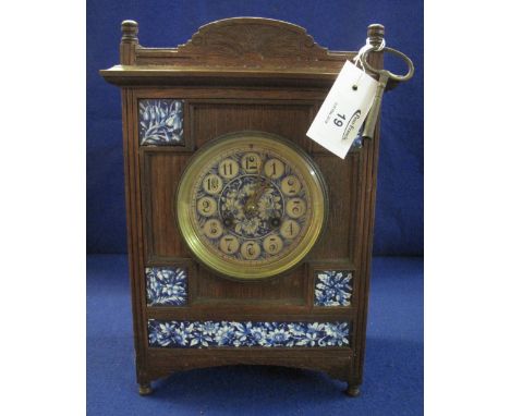 Early 20th Century oak Arts and Crafts design two train mantel clock with inset blue and white foliate panels and Arabic face