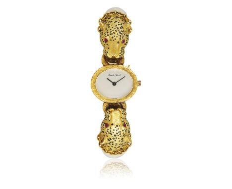 A GEM-SET BANGLE WATCH, BY BUECHE-GIROD & GAY FRÈRES, CIRCA 1970The hinged bangle terminating with roaring leopard's heads de