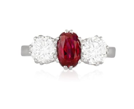 A RUBY AND DIAMOND THREE-STONE RINGThe cushion-shaped ruby between two brilliant-cut diamonds within claw-setting, mounted in