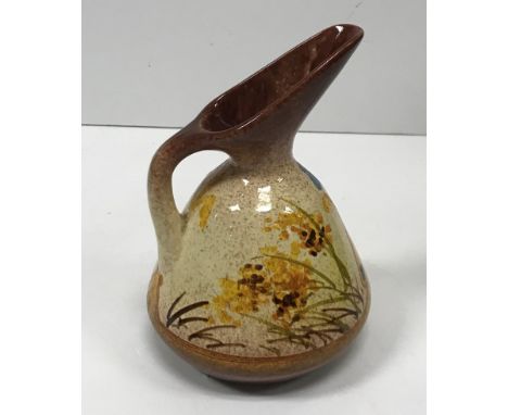 A William Ault Pottery ewer designed by Christopher Dresser with butterfly and foliate decoration probably painted by Clariss