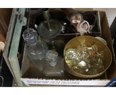A box containing assorted sundry items to include a collection of glass bottle stoppers, two decanters, a brass candlestick i