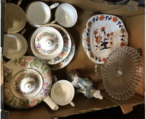 A box containing a Paragon "Country Lanes" part tea service, two Lladro figures, one of "Girl holding a pig", the other of "B