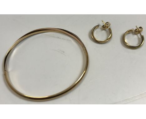 A 14 carat tri-colour gold bangle, 5.5/6 cm diameter, 9.7 g, together with a pair of matching hoop earrings, 2 cm diameter, 5