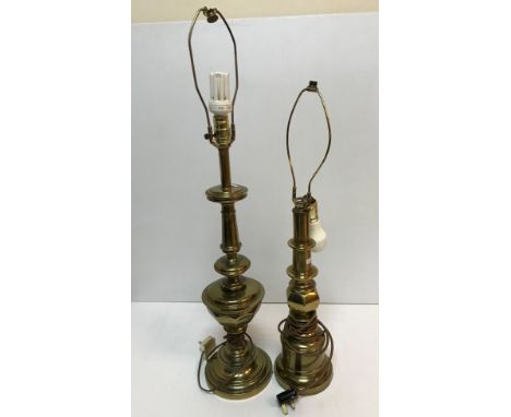 Two brass table lamps of column form both raised on circular stepped bases, one 67 cm high including light fitting, the other