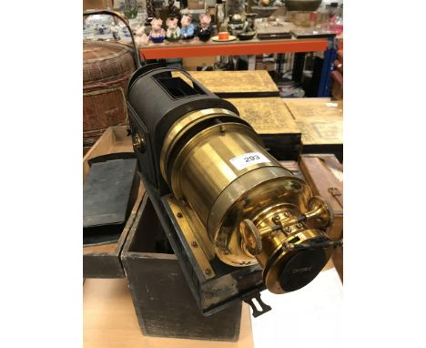 A Perken, Son &amp; Co Ltd Optimust magic lantern housed in a wooden box together with five boxes of assorted topographical l