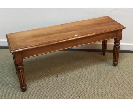 A good quality modern cherry wood window seat in the Victorian style, the single piece top with moulded edge raised on turned