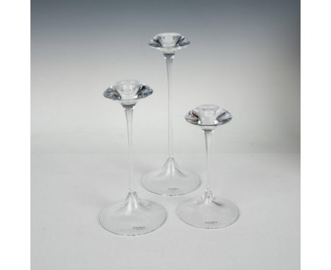 3 crystal-clear candlesticks of various sizes that feature a sleek round base, slender elongated neck, and a stylish cymbal-s
