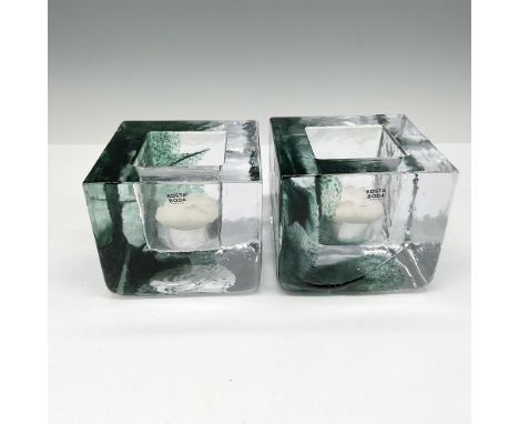 Mouth blown and hand formed cube design of clear crystal with green ribbon color. Kosta Boda mark. This item has its original