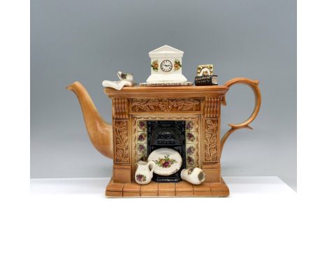 This decorative Titan Flueback teapot features a large fireplace decorated with Royal Albert's Old Country Roses pattern plat
