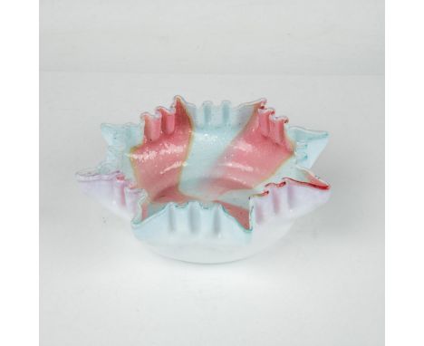 Beautifully hand-crafted, this bowl showcases high ruffled sides made from translucent light blue and pink art glass. The swi