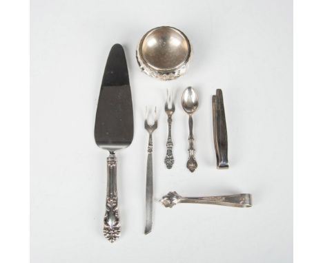 This eclectic collection includes a salt cellar, demitasse spoon marked International Silverplate, two olive or pickle forks,