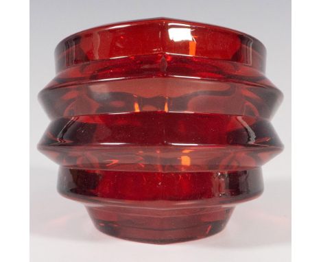A ruby-red colored crystal in an abstract form. Orrefors marked. This item has its original box: 4.5"L x 4.25"w x 3.75"H. Iss