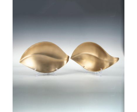 Two brushed metal leaf shaped bowls/trays in a muted bronze color 13"L x 7.75"W x 2"H. Includes original box 15"L x 9"W x 4"H