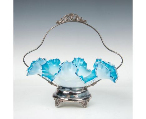 Lovely bride's basket footed pedestal frame with a scrollwork handle, accompanied by a ruffled art glass bowl. The bowl is ad