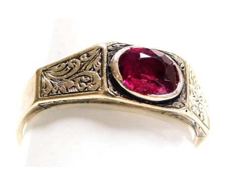 A late Georgian ruby solitaire ring, set with an oval cut ruby, in yellow metal, the shoulders with foliate engraved decorati