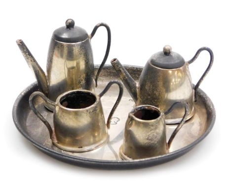 An Elizabeth II silver miniature tea and coffee set, comprising a circular tray, teapot, cream jug, sucrier, and coffee pot, 