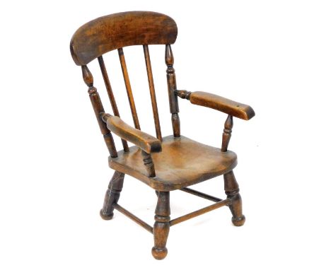 A 19thC beech and elm child's stick back Windsor chair, with solid saddle seat, raised on turned legs united by stretchers, 3