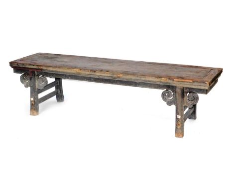 A Chinese hardwood low table, raised on scroll topped square legs, united by side stretchers, 51cm high, 195cm wide, 51cm dee