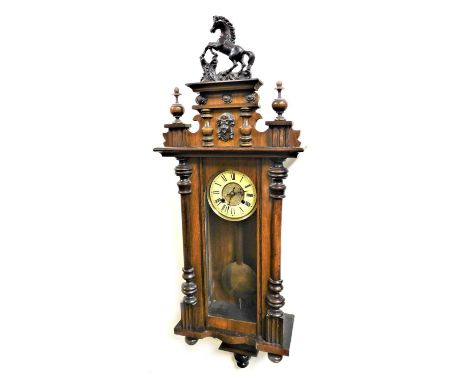 A late 19thC walnut cased Vienna wall clock, circular brass dial with chapter ring bearing Roman numerals, eight day movement