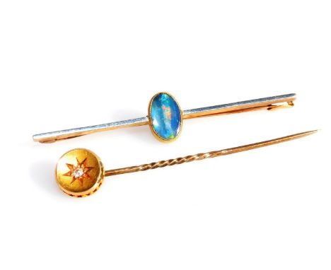 An Edwardian opal bar brooch, set in yellow metal, stamped 15ct, and a diamond set tie pin, set in yellow metal, stamped 15ct