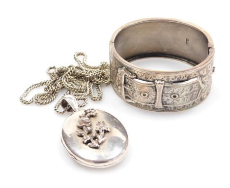 A silver buckle and strap bangle, with engraved foliate decoration, together with a double photo locket, with raised floral d
