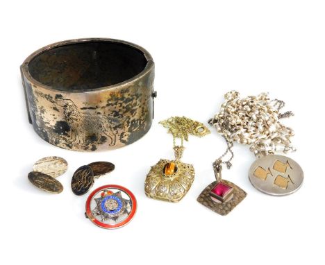 A George V silver bangle, on a snap clasp, engraved with a red setter, three silver pendants on chains, a pair of silver doub