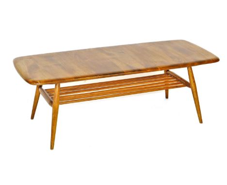 An Ercol light elm coffee table, the oblong shaped top raised on turned legs united by an undertier, 36cm high, 104cm wide, 4