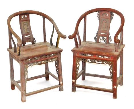 A pair of Chinese red and gilt lacquered  hardwood horseshoe armchairs, with figural carved scroll splats, solid seats, raise