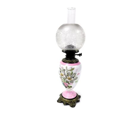 A late 19thC Hinks's duplex porcelain oil lamp, painted with flowers within a pink ground, with a brass mount and base, glass